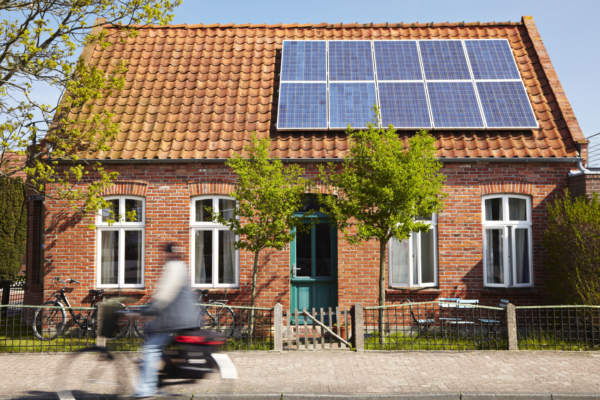 Little Traditional northern Brick house with photovoltaic technology on the roof